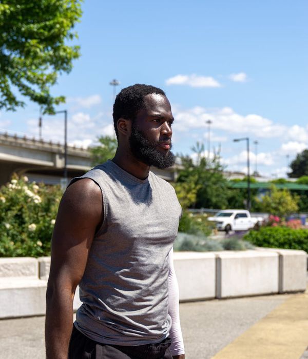 Man performing a strength exercise in a bright, modern space.