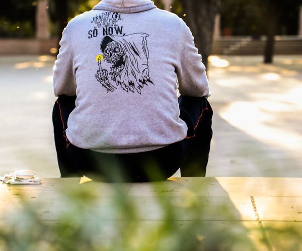 Man stretching outdoors with a serene landscape in the background.